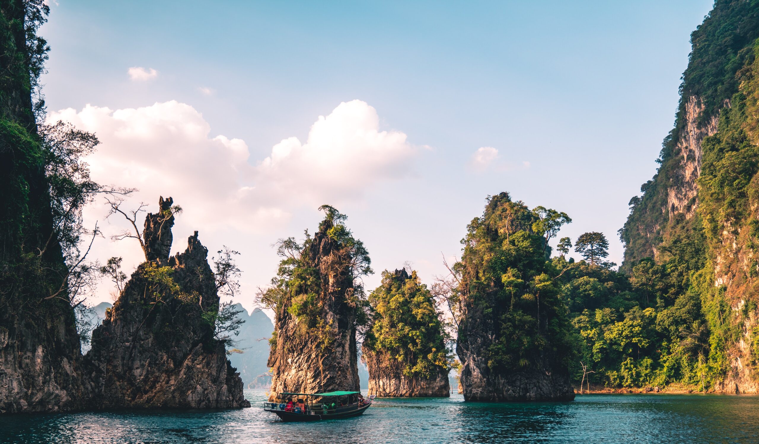 several large limestones in the lakes of Khao Sok National Park in Thailand / how to get from Phuket Airport to Khao Sok National Park