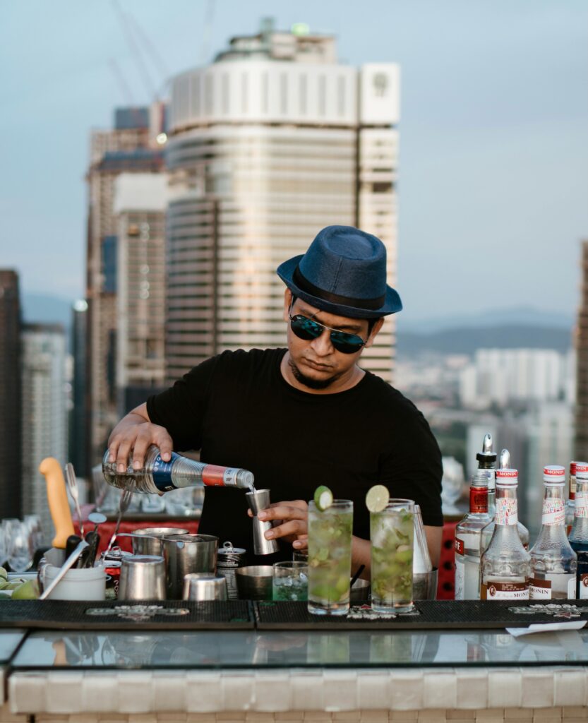 a bartender making a drink on a rooftop bar in Kuala Lumpur, Malaysia 