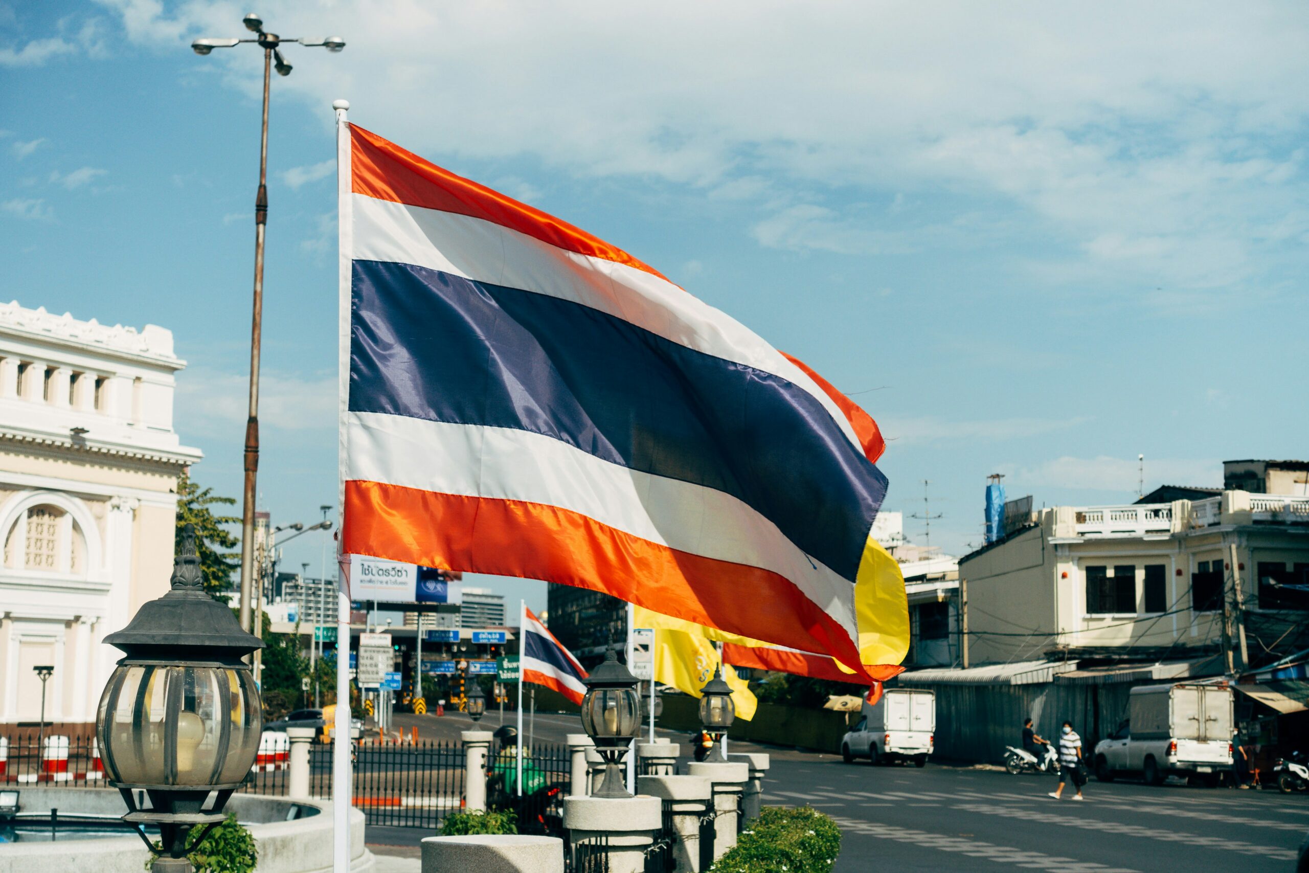 the Thai Flag on a poll in the city centre of Bangkok / tipping in Thailand