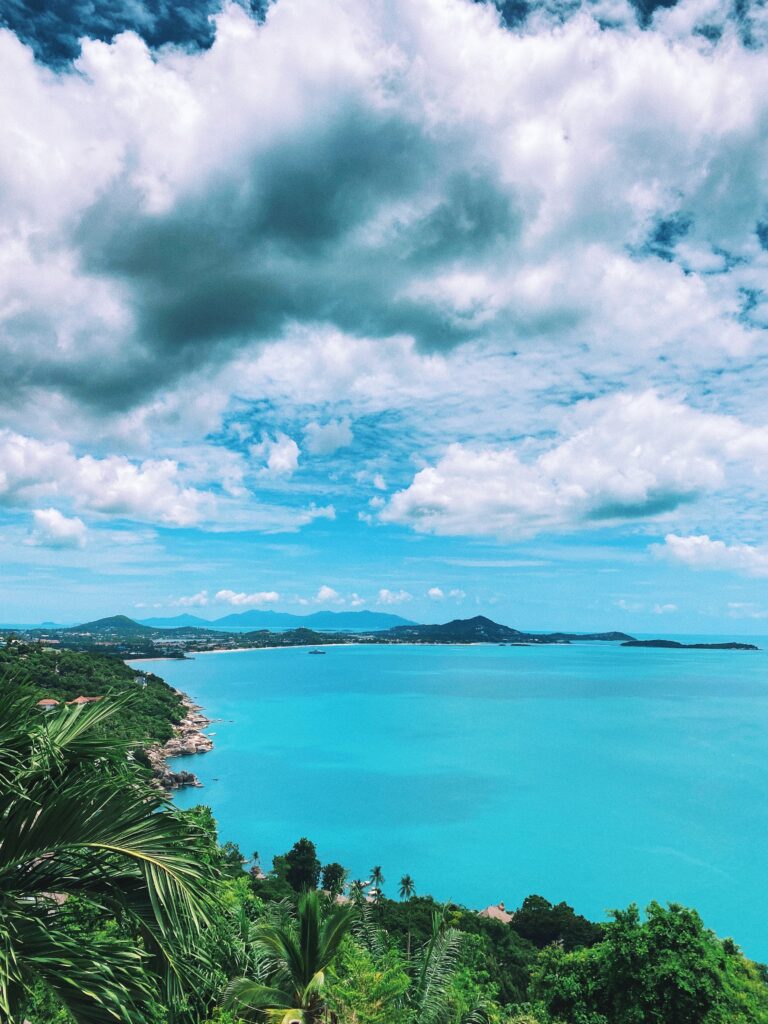 views from a viewpoint in Koh Samui showing bright shades of turquoise waters on a clear sky day in Koh Samui 