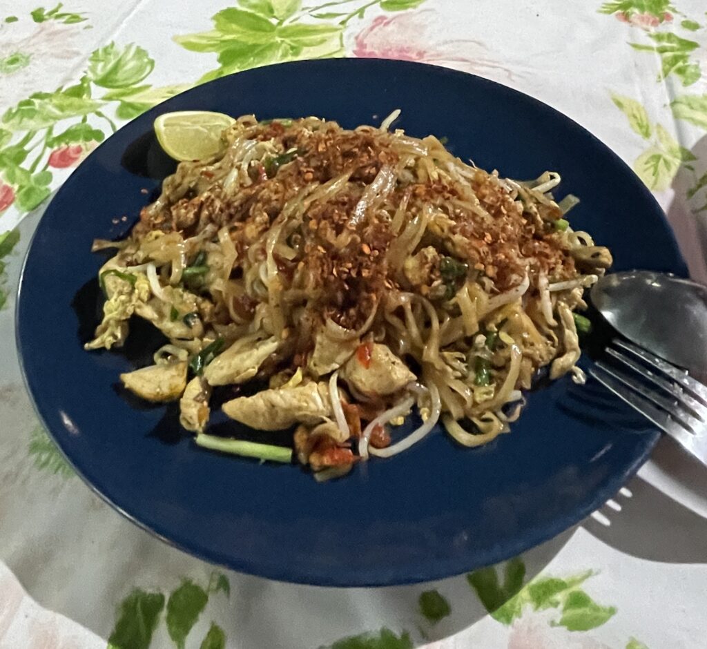 a pad thai dish with lots of chili on it after a cooking course 