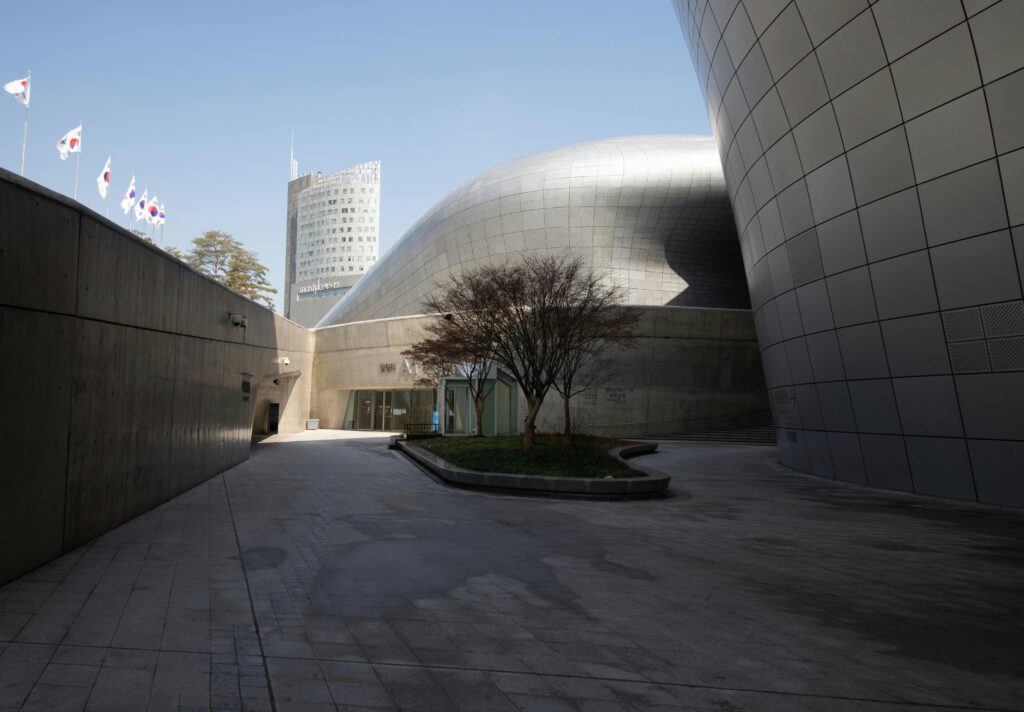 the remarkable Dongdaemun Design Plaza building in Seoul on a sunny day, designed by Zara Hadid