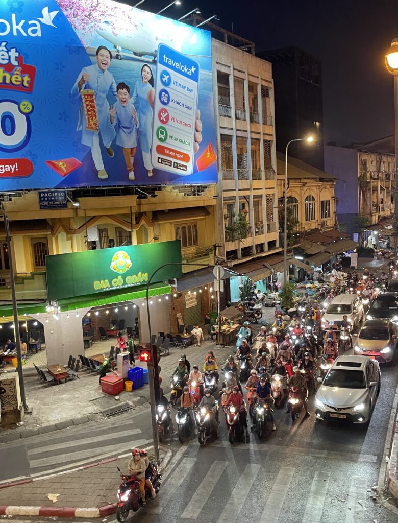 many scooter drivers waiting a t a stop light in Ho Chi Minh City, Vietnam
