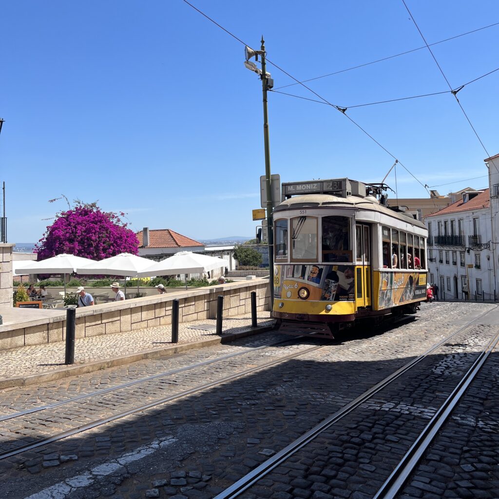 a classic white/yellow streetcar in Lisbon, Portugal
