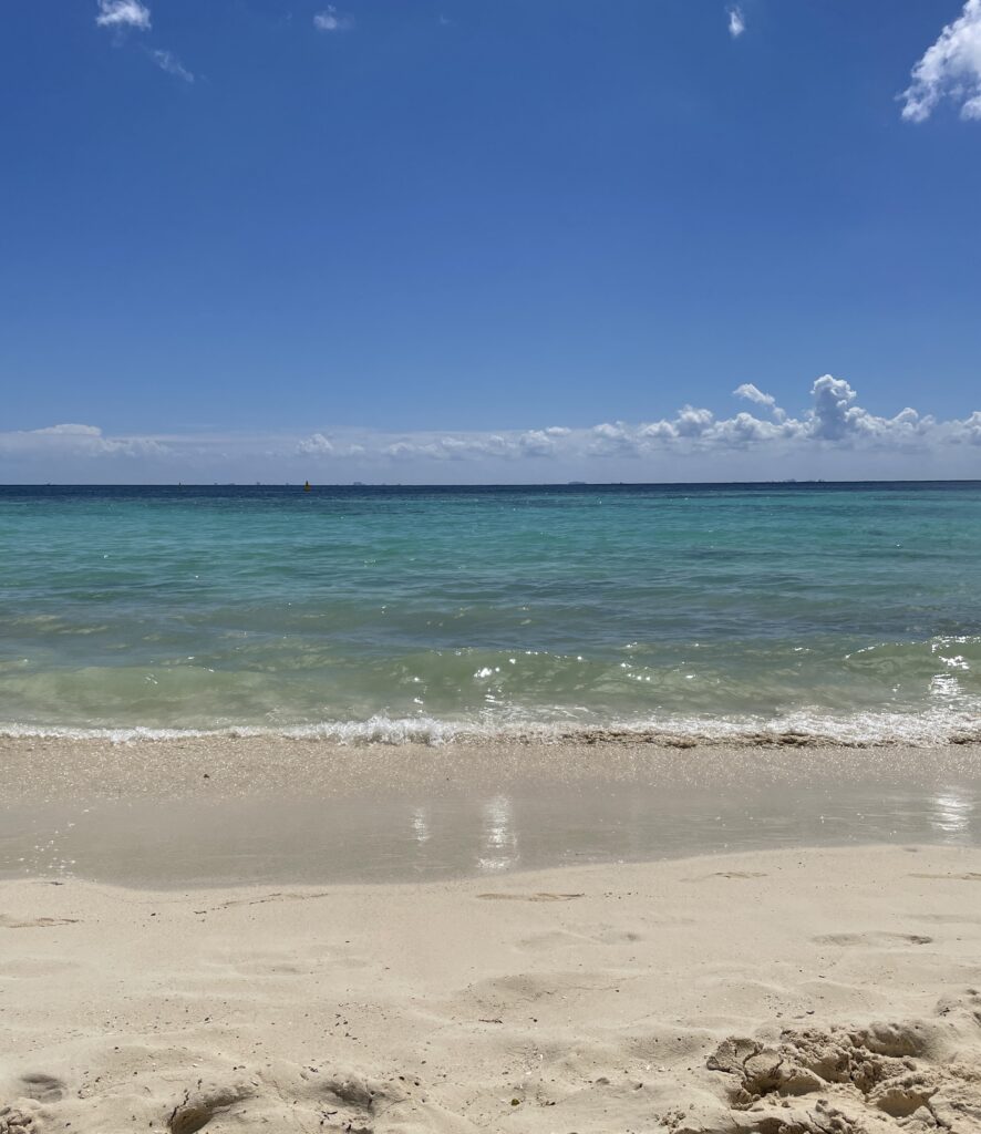 crystal clear waters with various shades on a perfect beach day in Playa del carmen 
