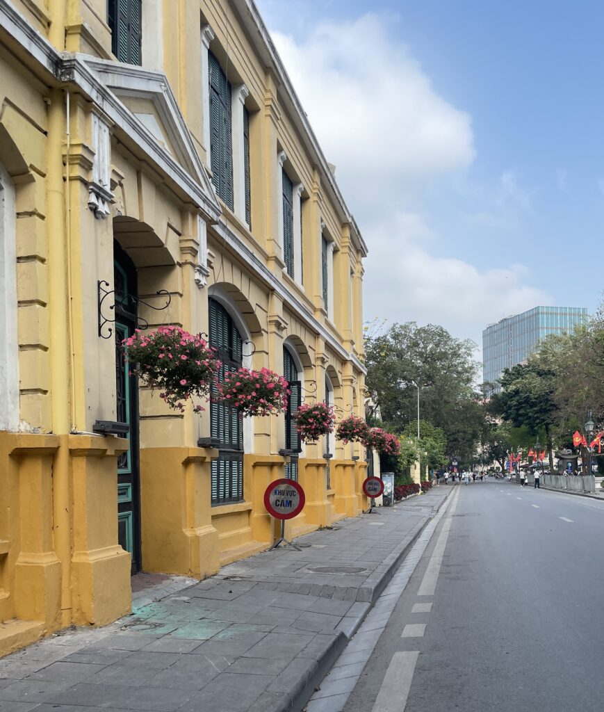 a stunning yellow old building on a sunny day in Hanoi, Vietnam