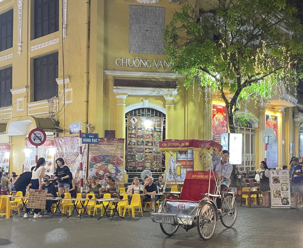 A local riding a cyclo in the Old Quarter of Hanoi