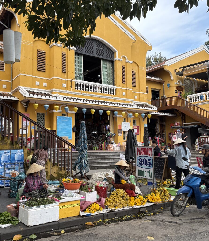 a few Vietnamese market vendors at the market in Hoi An in the afternoon