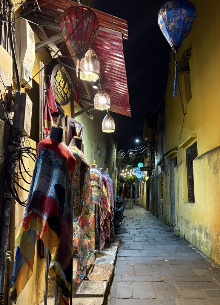 dresses displayed at a shop in Hoi An in a quiet alleyway in the Old Town