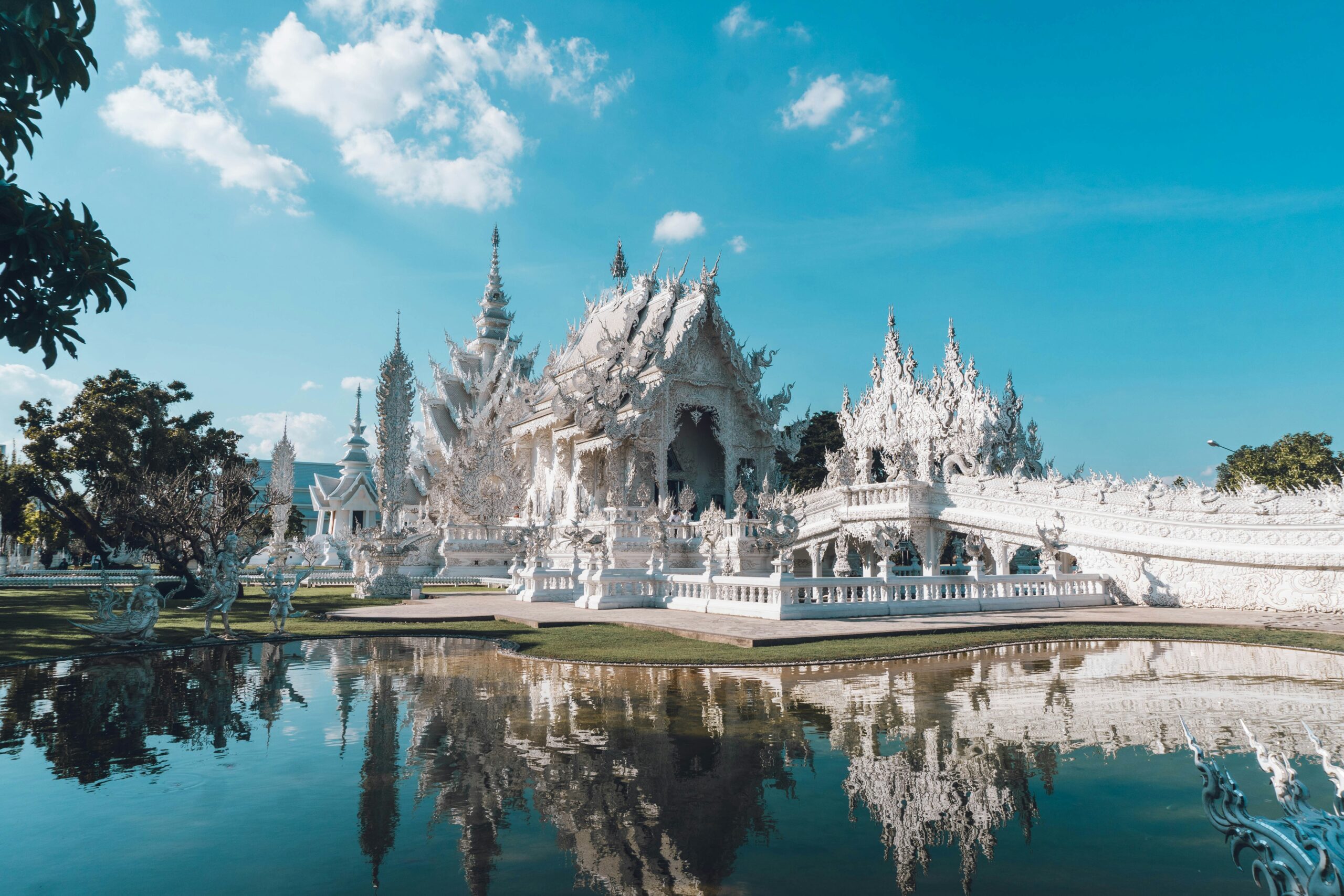 The striking White Temple (Wat Rong Khun) in Chiang Rai, Thailand with intricate white carvings and mirrored details