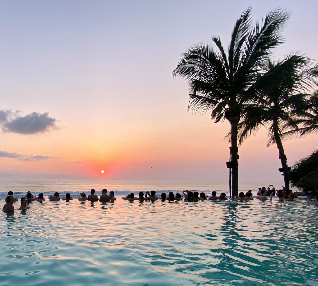 Sunset at Potato Head Beach Club in Bali, featuring poolside views, modern design, and travelers enjoying the vibrant evening atmosphere.
