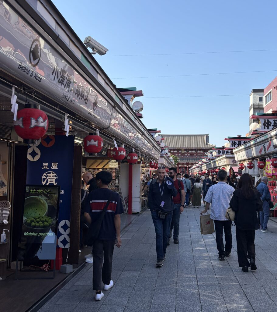 Tourists and locals walking along Nakamise Street toward Senso-ji Temple in Asakusa, a traditional neighborhood to stay in Tokyo
