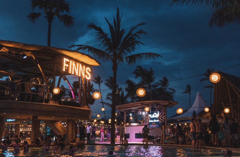 Finns Beach Club at night in Bali with glowing pools and party lights, ranked among the best beach clubs in Bali