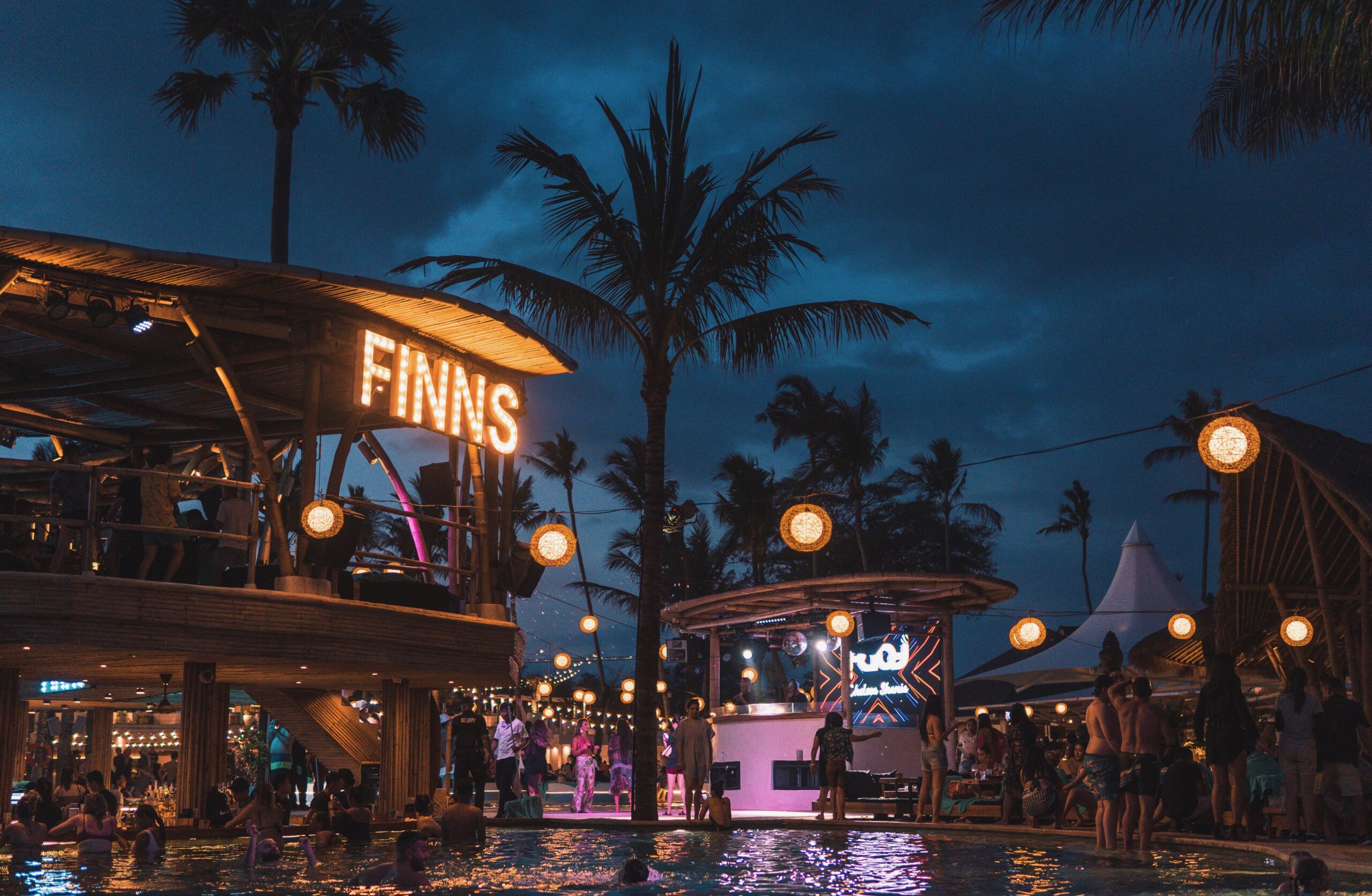 Finns Beach Club at night in Bali with glowing pools and party lights, ranked among the best beach clubs in Bali