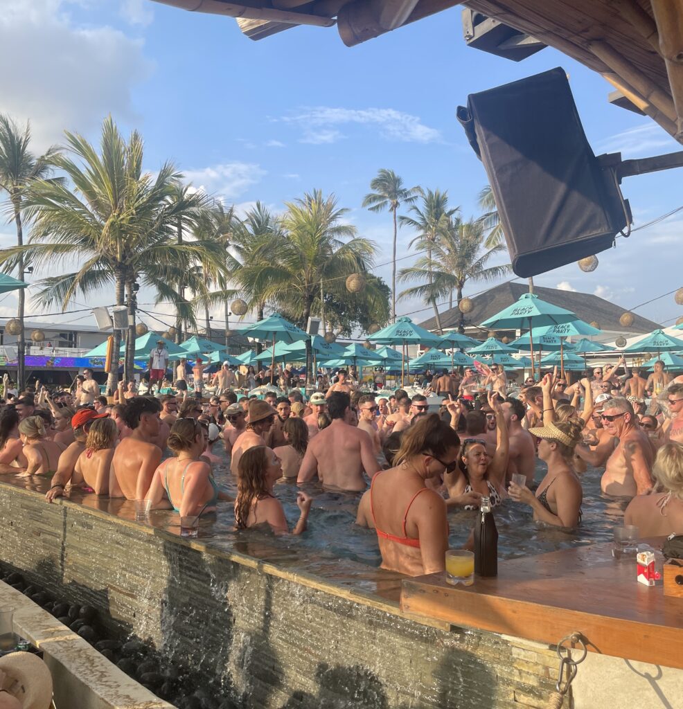 Daytime crowd partying at Finns Beach Club in Bali, full pool scene at one of the island’s best beach clubs