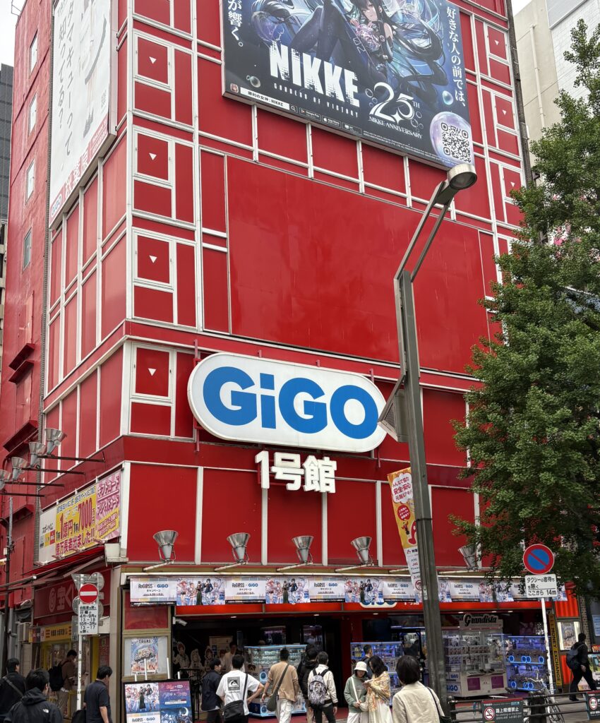 Gigo Arcade in Akihabara with colorful neon signs and people walking by in Tokyo