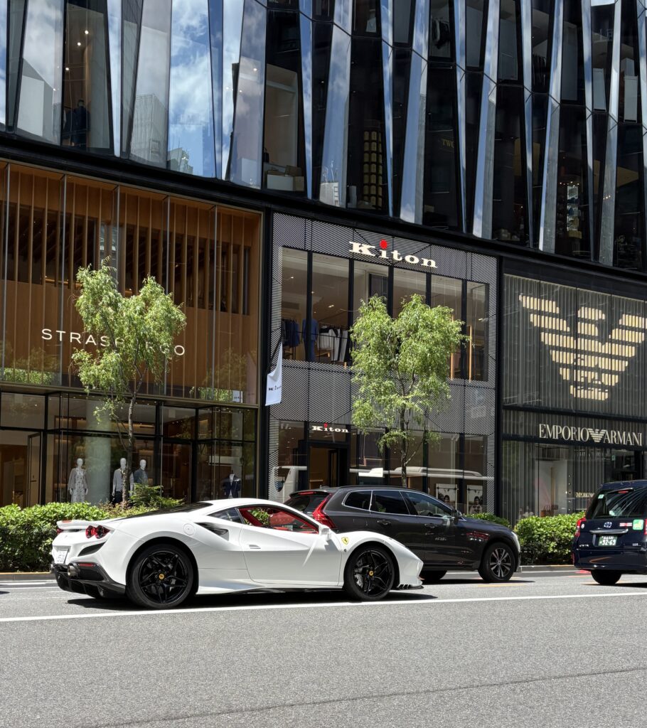 Upscale shopping street in Ginza Tokyo with Ferrari and luxury boutiques