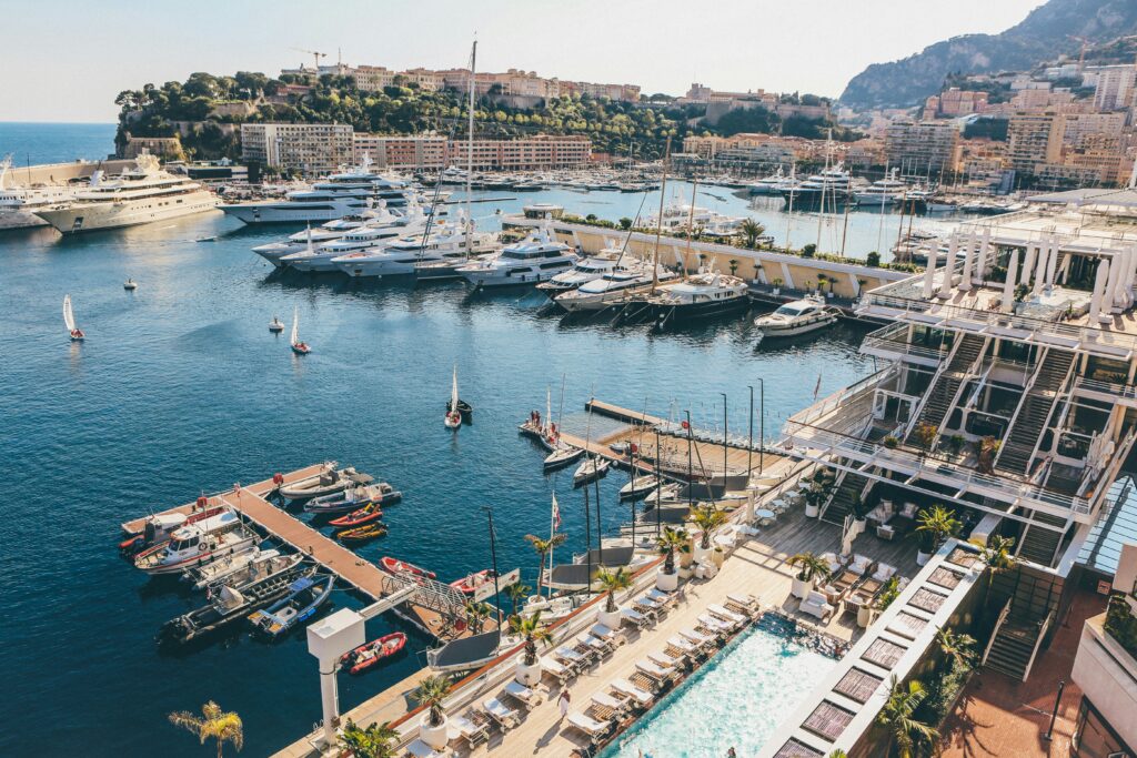 Scenic view of Monaco’s harbor with moored yachts and city buildings in the background