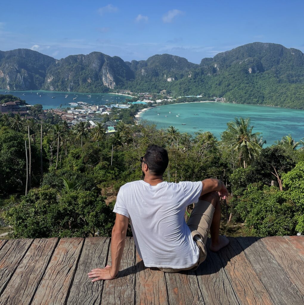 Traveler at Phi Phi viewpoint overlooking tropical islands and turquoise water in Thailand