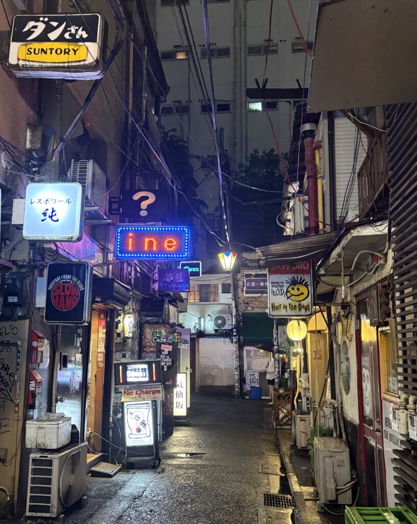 Shinjuku Golden Gai at night with rows of tiny bars, famous nightlife area in Tokyo
