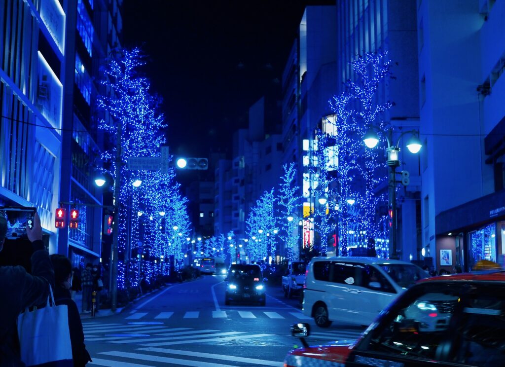 Shinjuku street decorated with festive blue holiday lights and seasonal decor in Tokyo