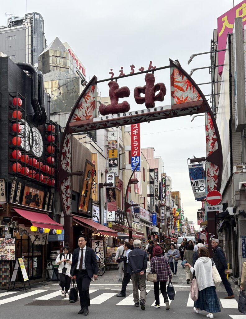 People walking along a vibrant street in Ueno, a top area to stay in Tokyo for culture and museums