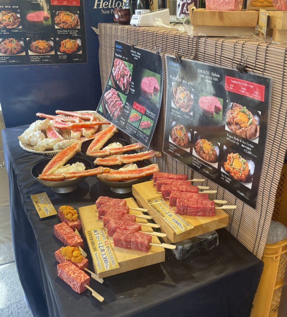 Wagyu beef skewers being grilled at Toyosu Fish Market in Tokyo