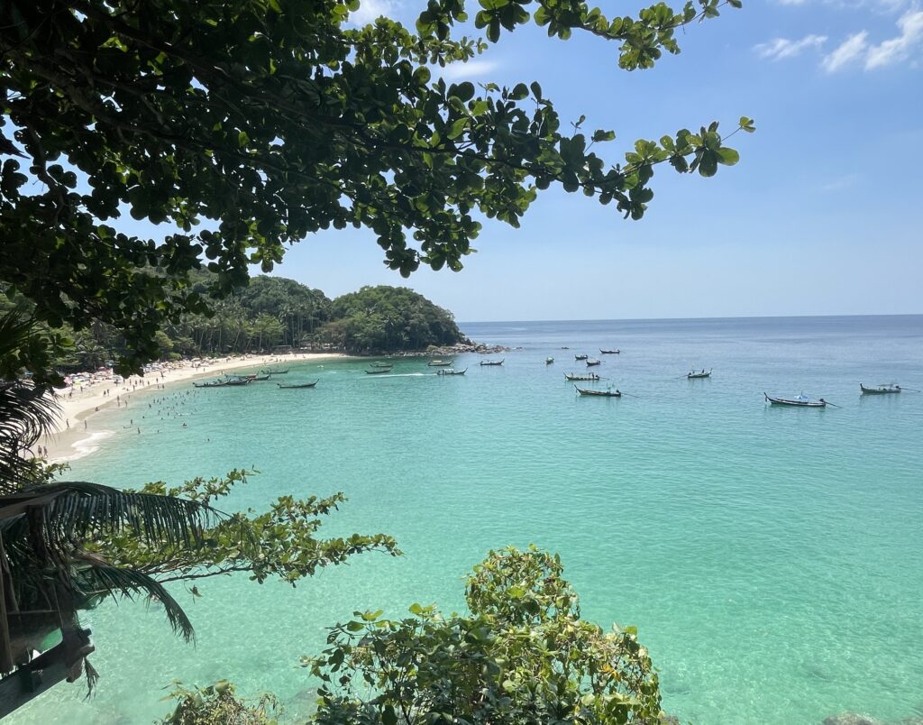 Featured image of multiple boats anchored in the turquoise waters off Freedom Beach in Phuket, Thailand