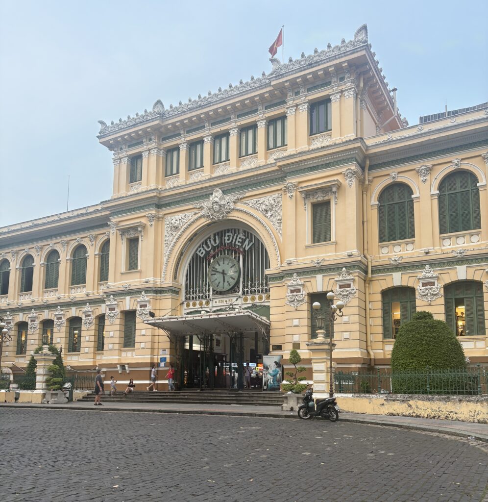 Front view of the stunning Ho Chi Minh City Post Office with its iconic yellow facade and French colonial design