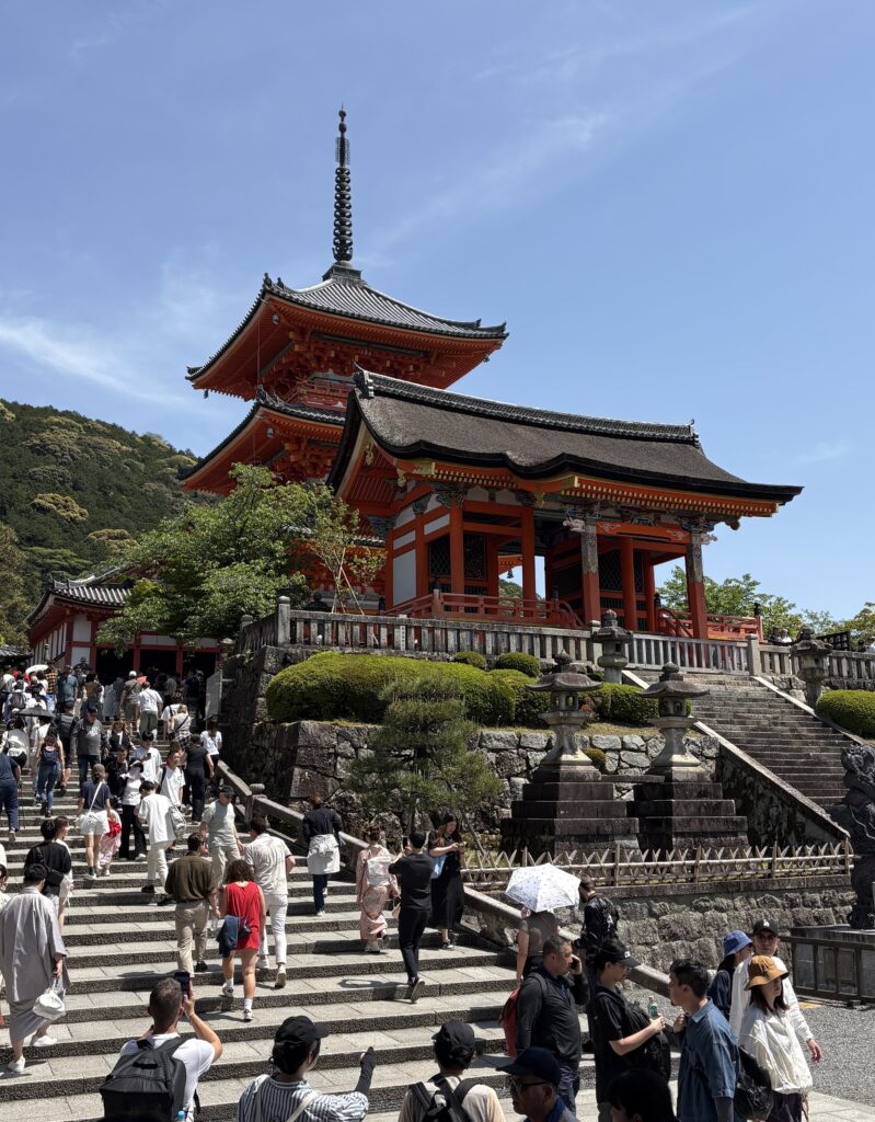 Large crowd of tourists gathered at a famous temple in Kyoto, capturing the city’s cultural appeal and popularity.