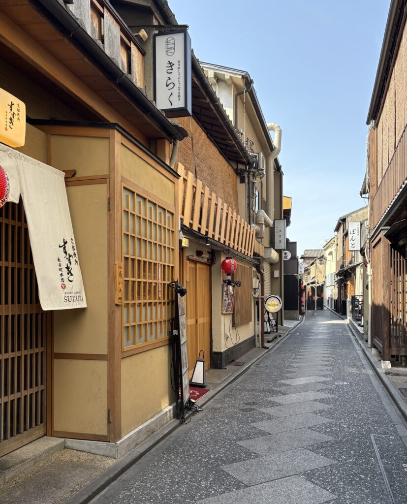 Quiet street in Kyoto lined with traditional Japanese houses and preserved wooden architecture.