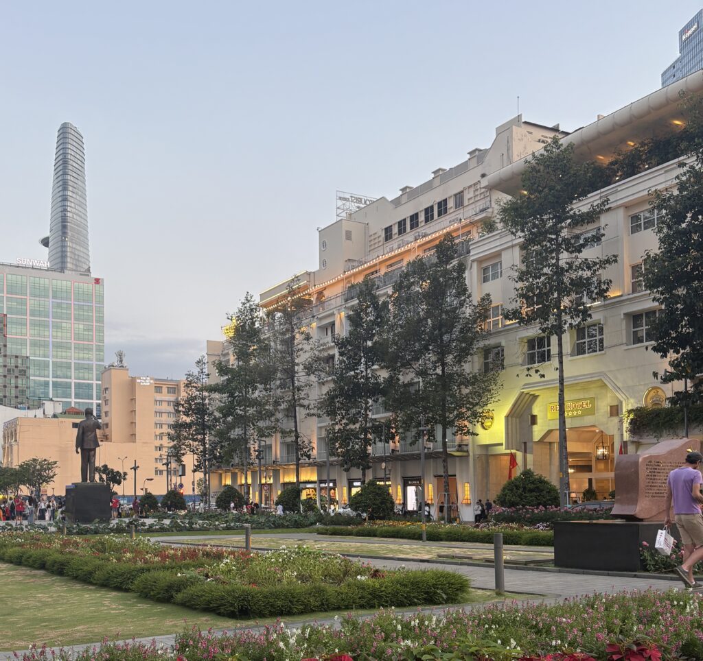 Back view of Ho Chi Minh statue in the main square with Parisian-style colonial buildings in Don Khoi area