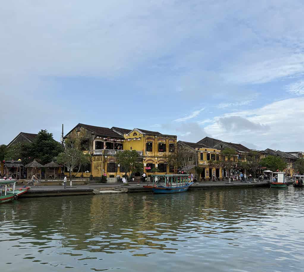 Peaceful morning view of Hoi An Old Town taken from An Hoi Island, with yellow buildings and quiet streets along the river.
