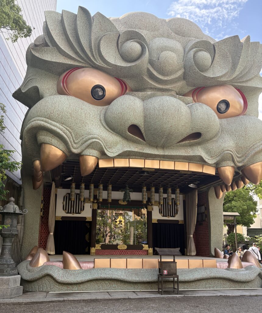Photo of Namba Yasaka Jinja in Osaka, featuring the iconic lion-head-shaped shrine structure on a clear day.
