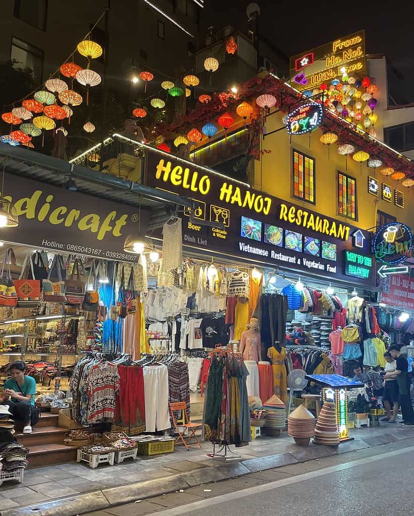 A vibrant store in Hanoi’s Old Quarter at evening time, filled with brightly lit lanterns and assorted goods.