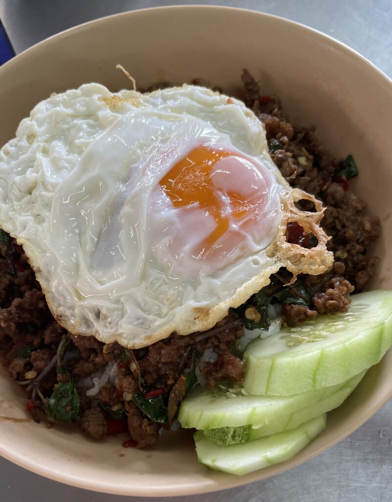 Pad Kra Pao with a fried runny egg on top served at Pad Thai Shop in Karon Beach, Phuket