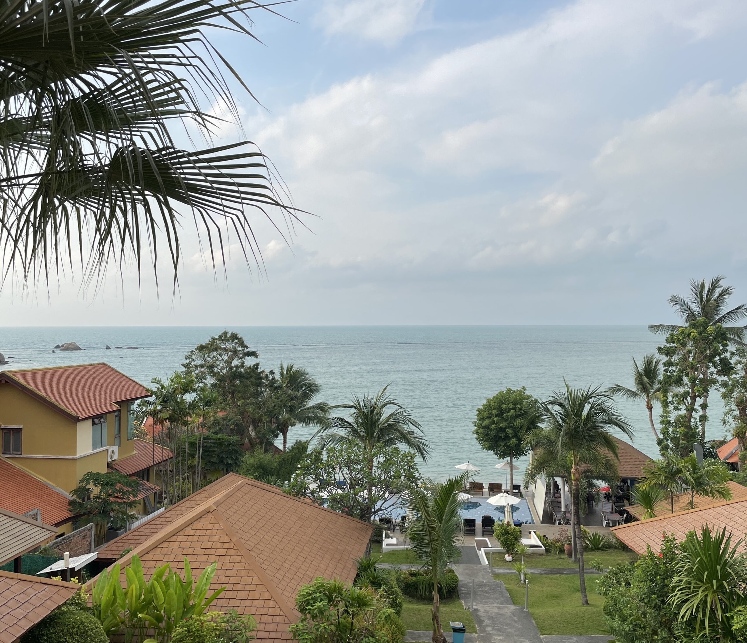Panoramic ocean view from a hotel room in Koh Samui, Thailand, showcasing turquoise water and tropical scenery