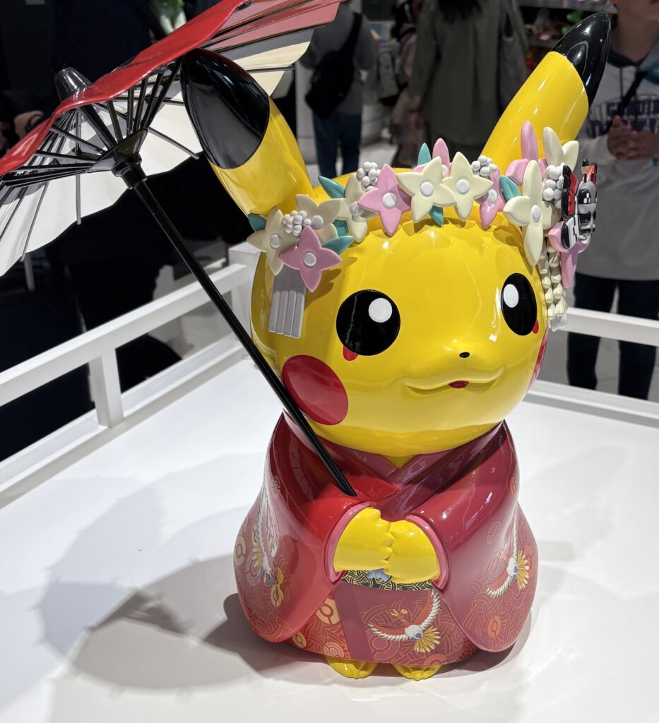 Adorably dressed Pikachu in a traditional Japanese kimono at Kyoto’s Pokémon Center, blending kawaii charm with local culture.