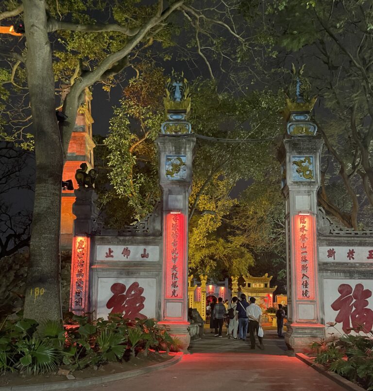 Tourists visiting a red-lit temple at Hoan Kiem Lake in Hanoi