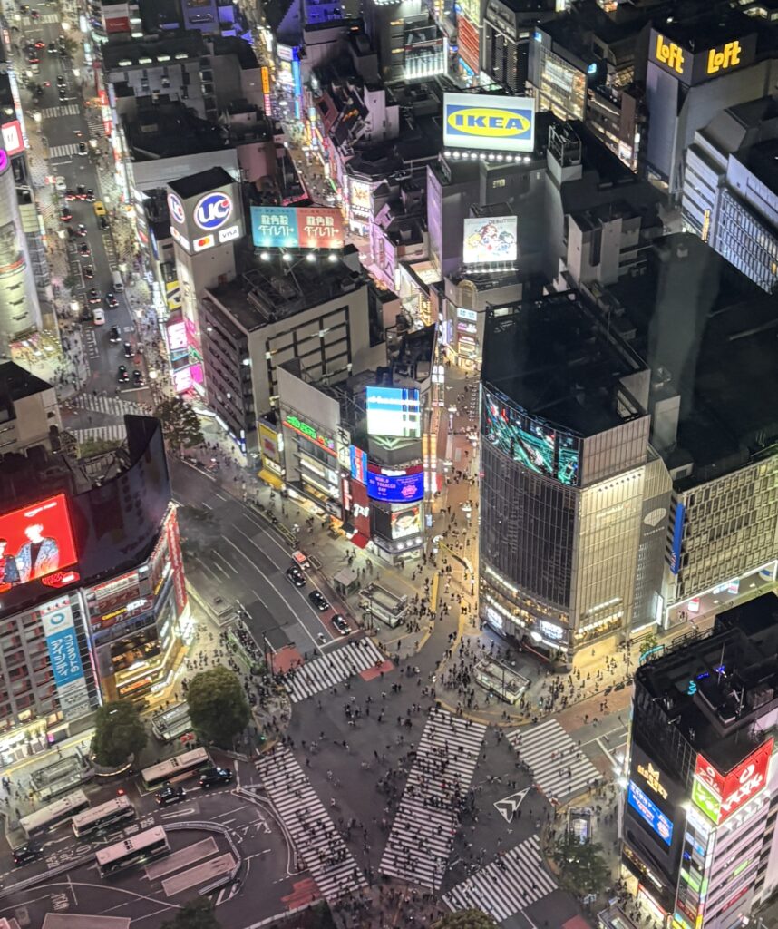 Nighttime cityscape of Tokyo from Shibuya Sky observation deck, glowing with lights