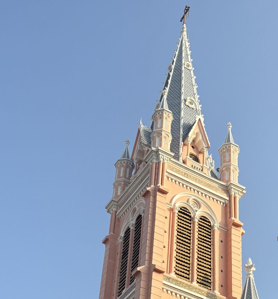 Close-up view of the iconic pink Tan Dinh Church in Ho Chi Minh City on a sunny day
