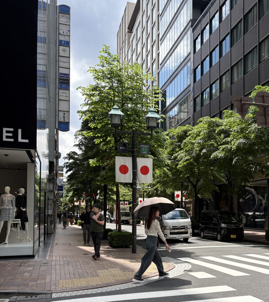 Sunny spring day in Tokyo with locals strolling along the street, enjoying the warm weather