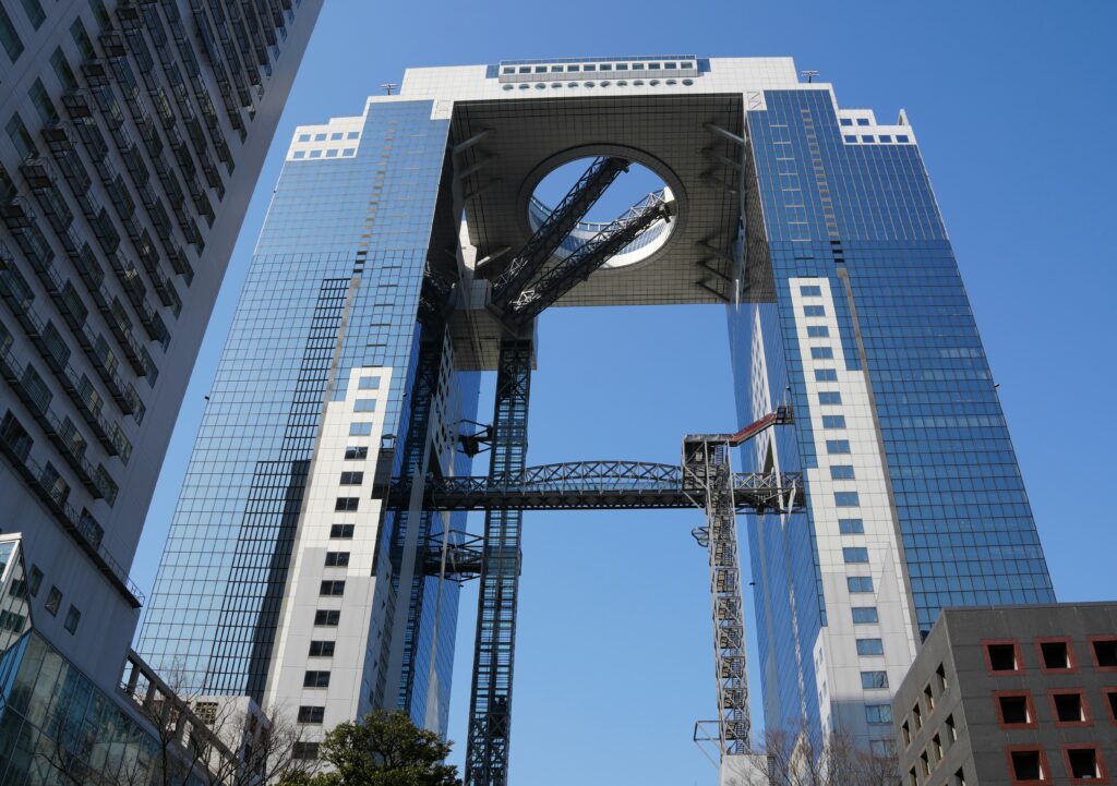 Umeda Sky Building in Osaka on a clear day, showcasing its futuristic architecture and open-air observatory.