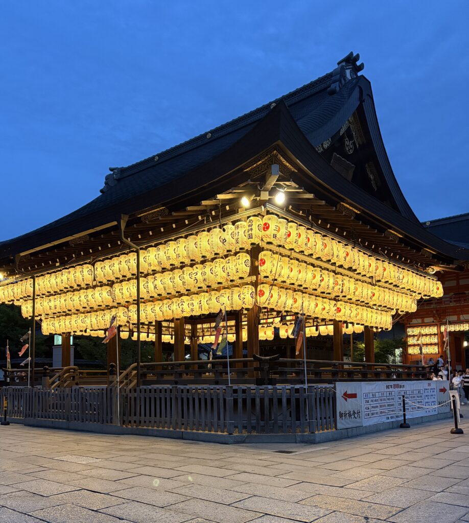 Yasaka Shrine illuminated at night with dozens of glowing lanterns, creating a serene and atmospheric view in Kyoto.