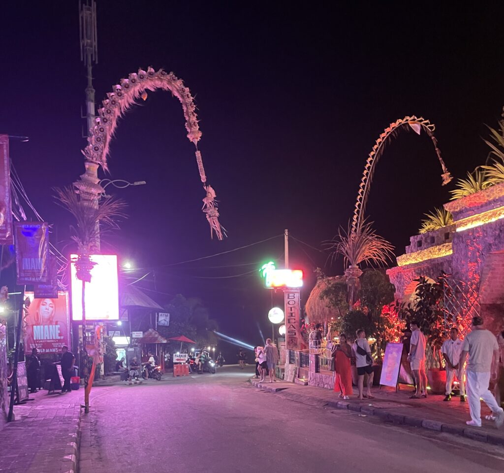Batu Bolong Street in Canggu at night with bars, nightclubs, and tourists