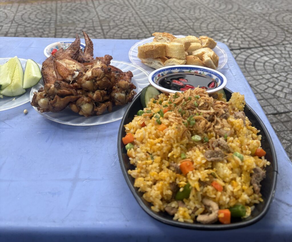 Beef fried rice with chicken wings, fresh banh mi bread, and Vietnamese soy chili sauce