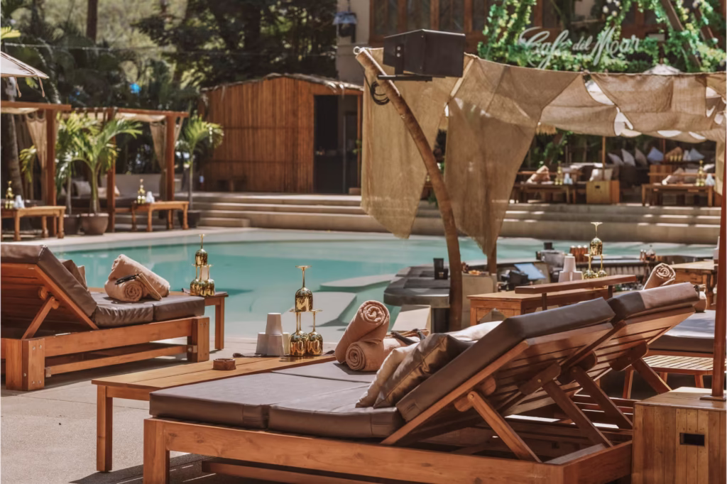 Luxurious daybeds and poolside cabanas with gold-rimmed glasses at Café Del Mar in Phuket.
