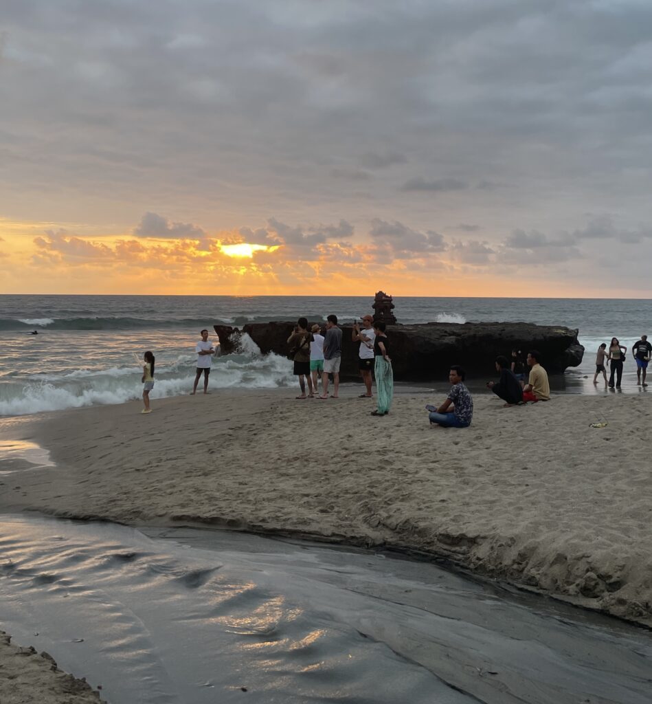 Sunset at Canggu’s main beach in Bali with rough, grainy sand showing the less idyllic side of Bali’s popular coastline