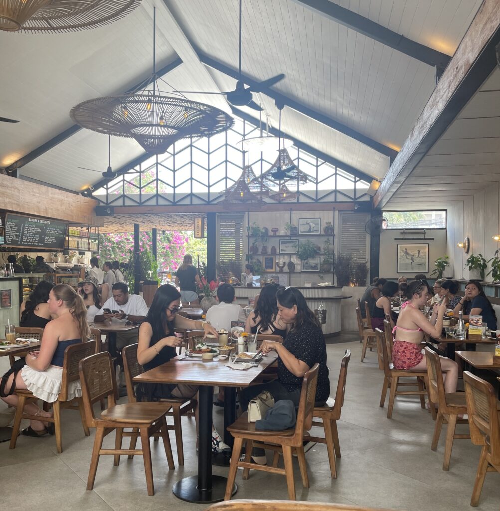 Busy and popular brunch spot Milk & Madu in Bali with many tourists dining and enjoying brunch
