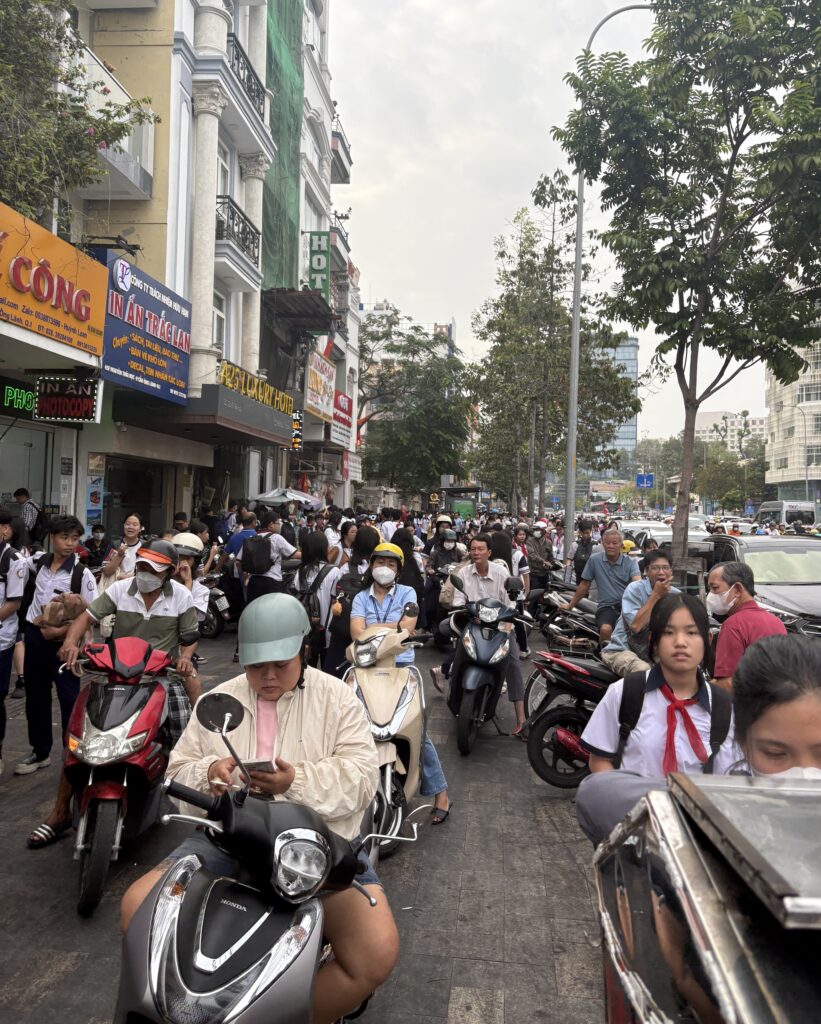 Scooters crammed on a sidewalk in Saigon during rush hour traffic in Vietnam.
